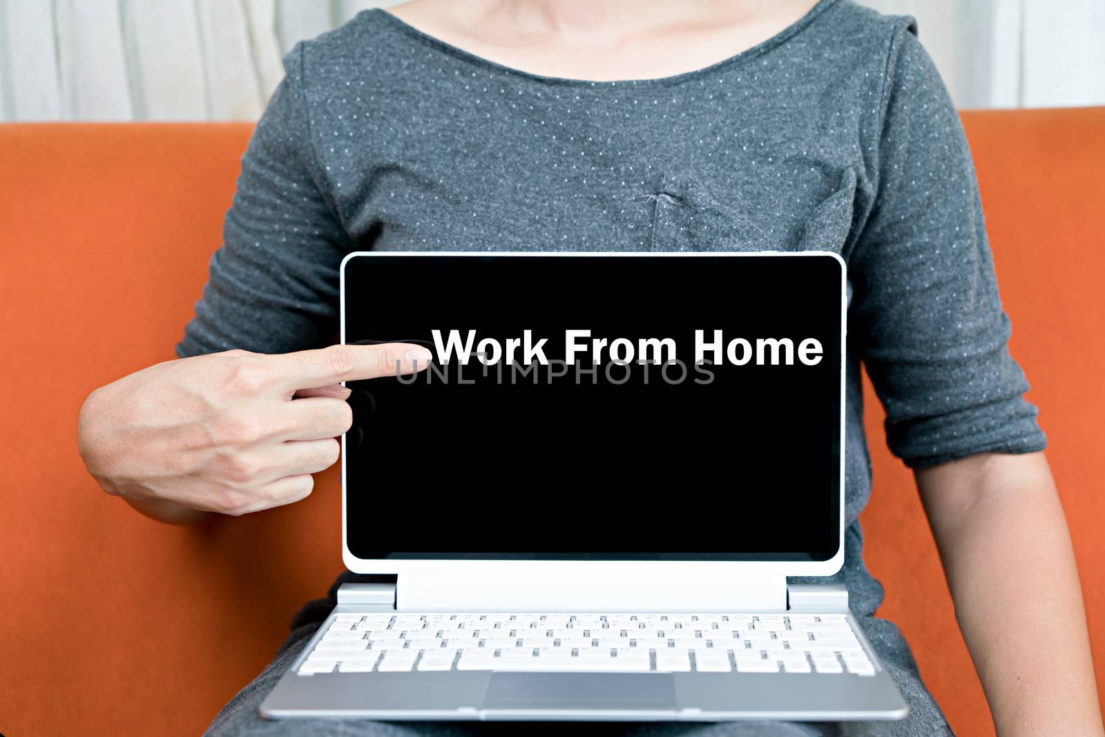 Hand choose work from home on laptop by Buttus_casso