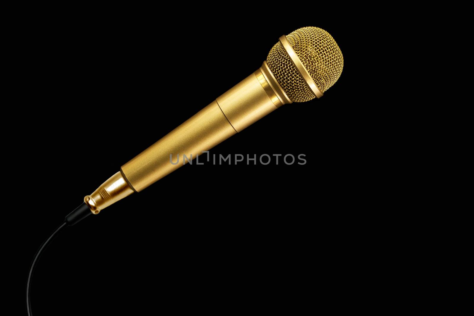 Golden microphone with cable on black background.