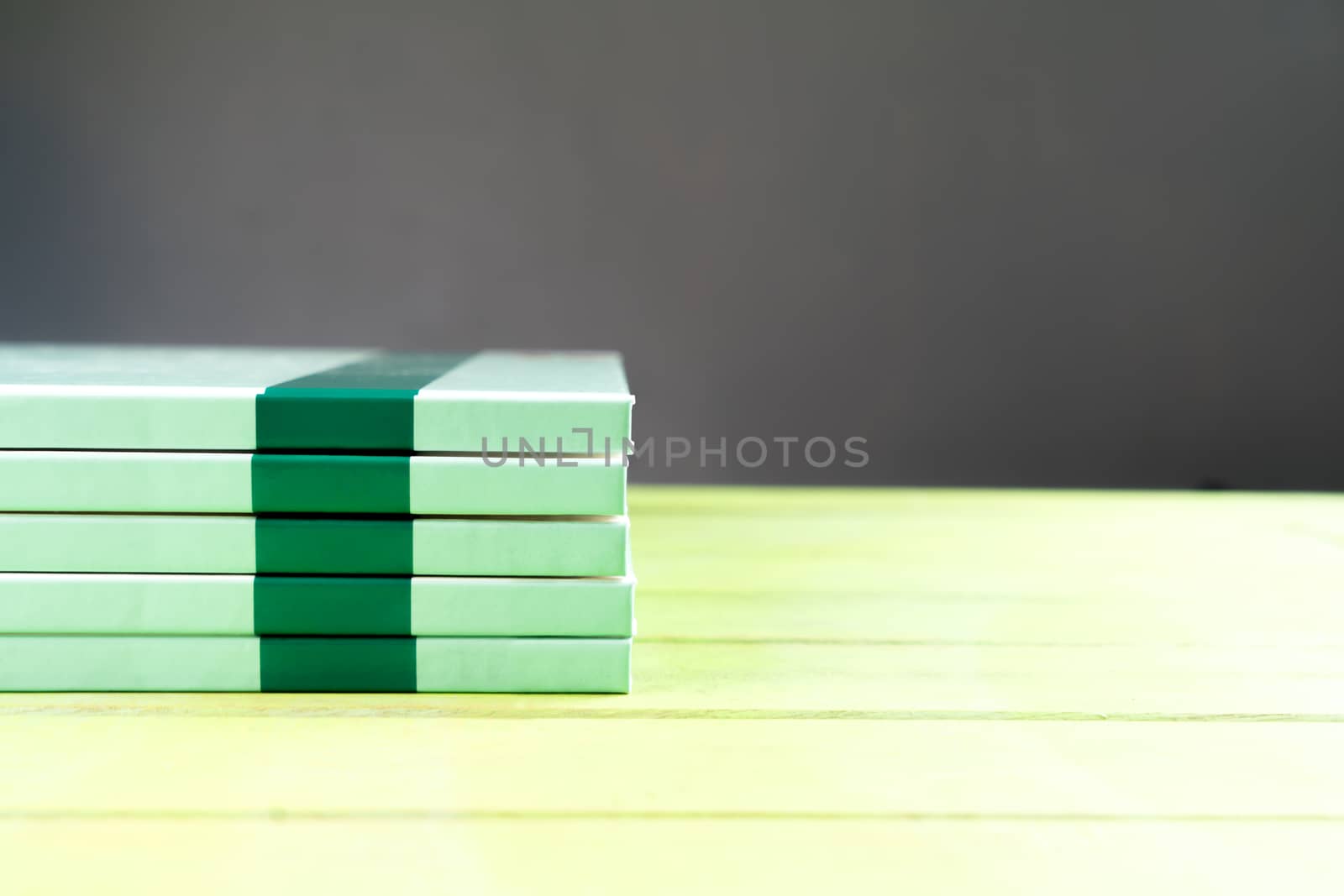 Stack book on wooden table on black background