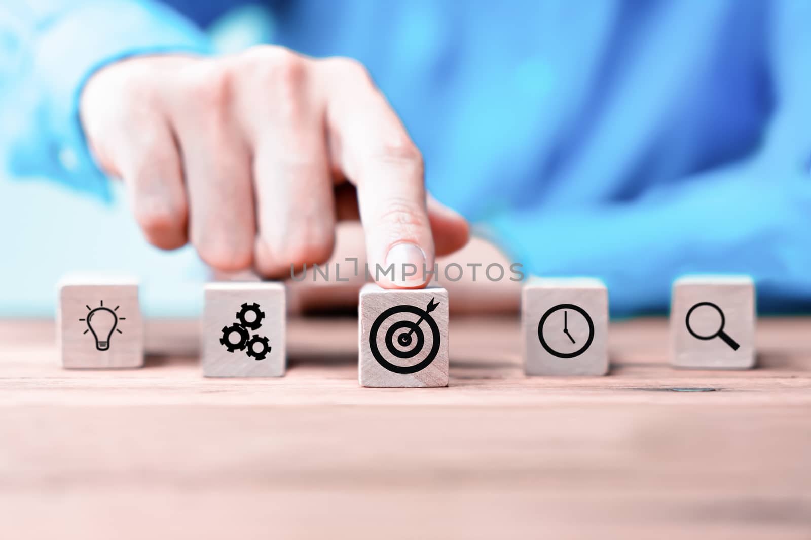 Businessman hand arranging wood block with icon business strategy