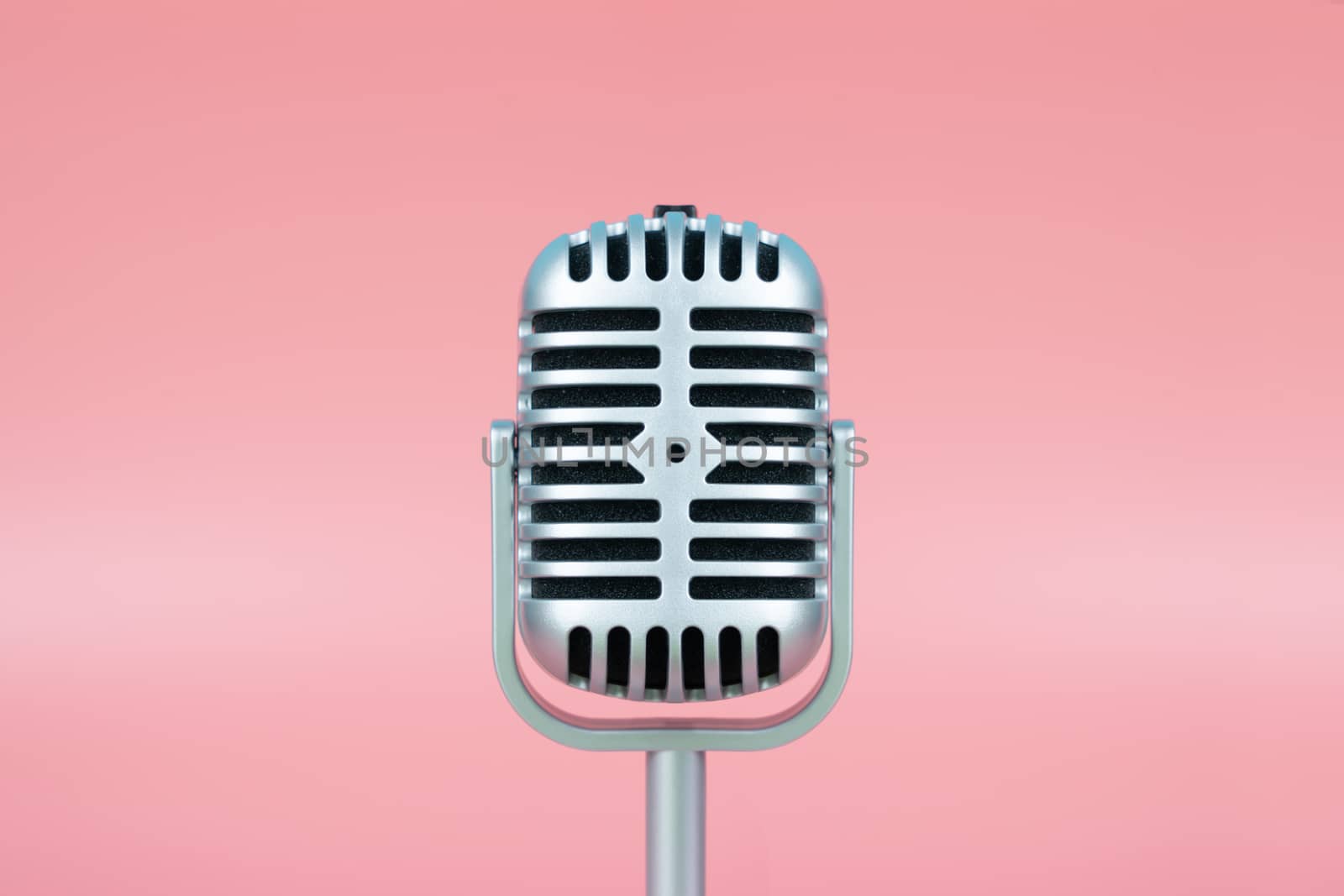 Retro microphone with copy space on pink background