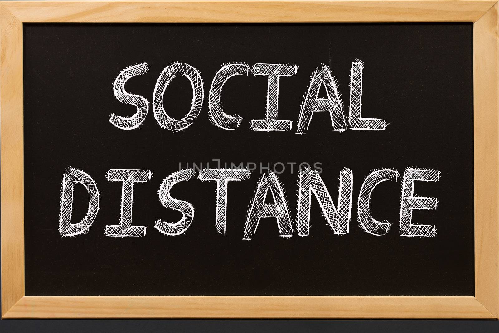Social distance text on blackboard by Buttus_casso