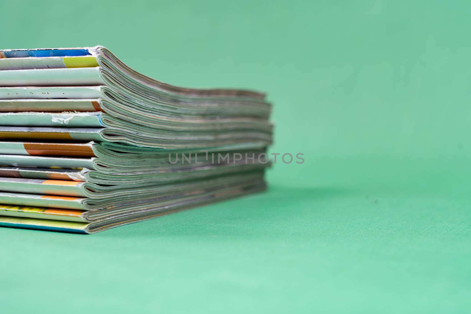 Stack magazines on green background by Buttus_casso