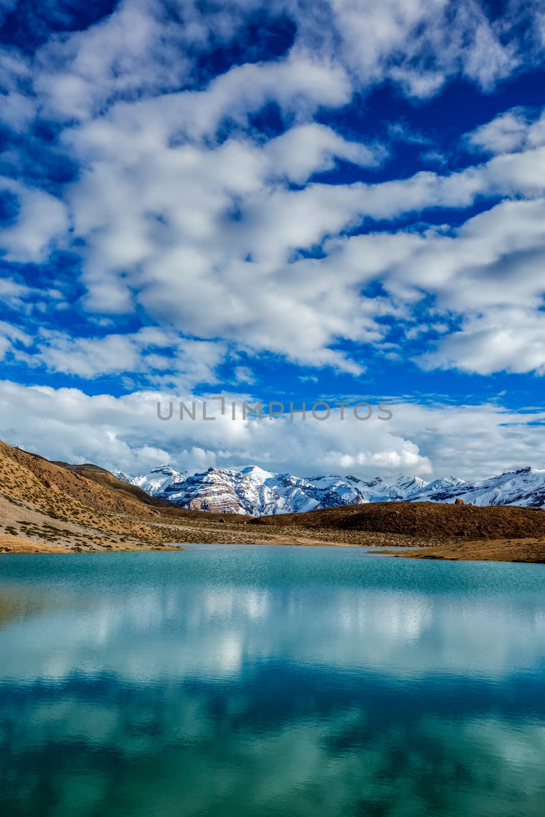 Himalayas mountains refelcting in mountain lake Dhankar Lake. Spiti Valley, Himachal Pradesh, India