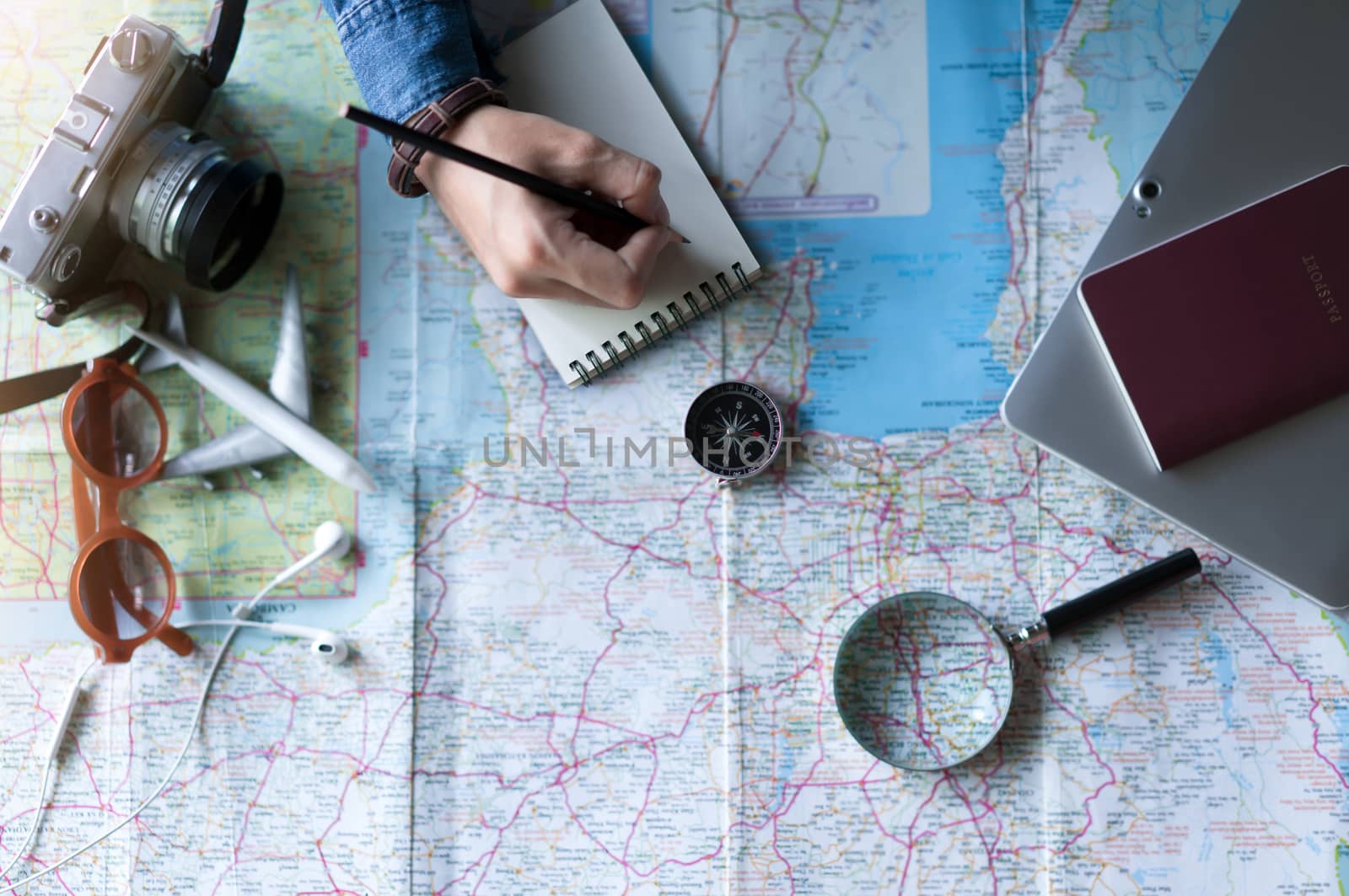 Compass and hand to planning vacation trip and accessories for travel
