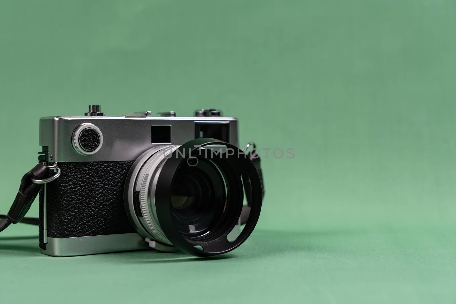 Retro camera with copy space on green background