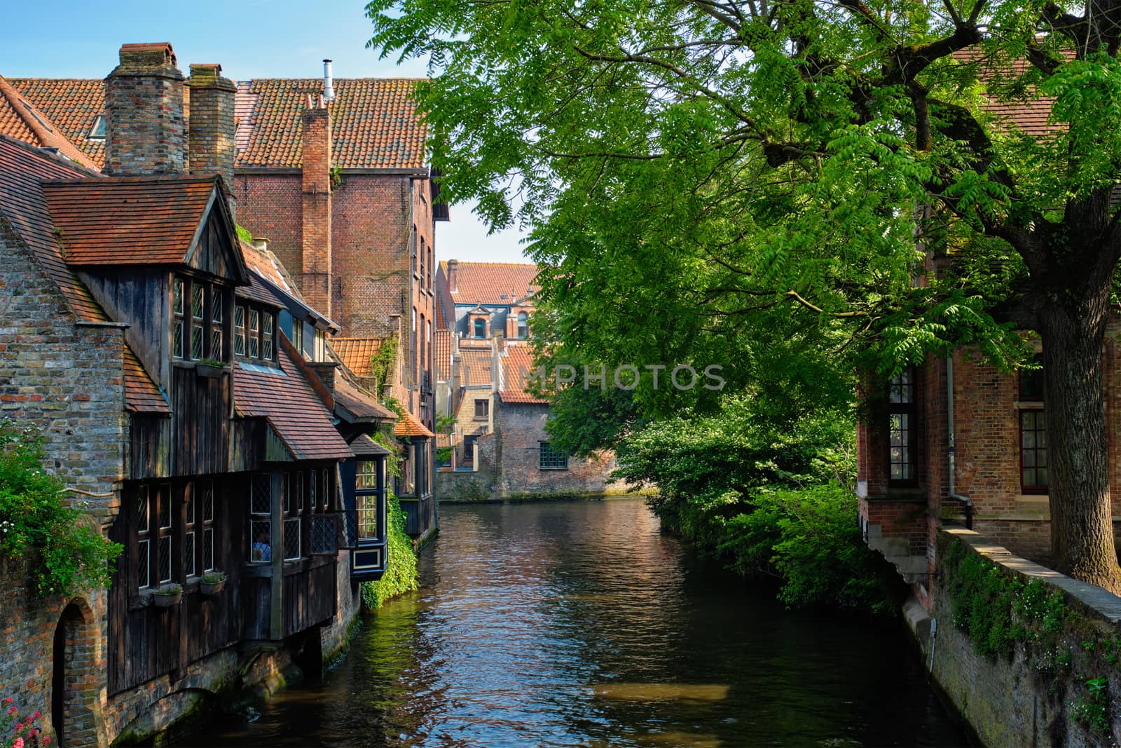 Canal between old houses of famous Flemish medieval city Brugge. Bruges, Belgium