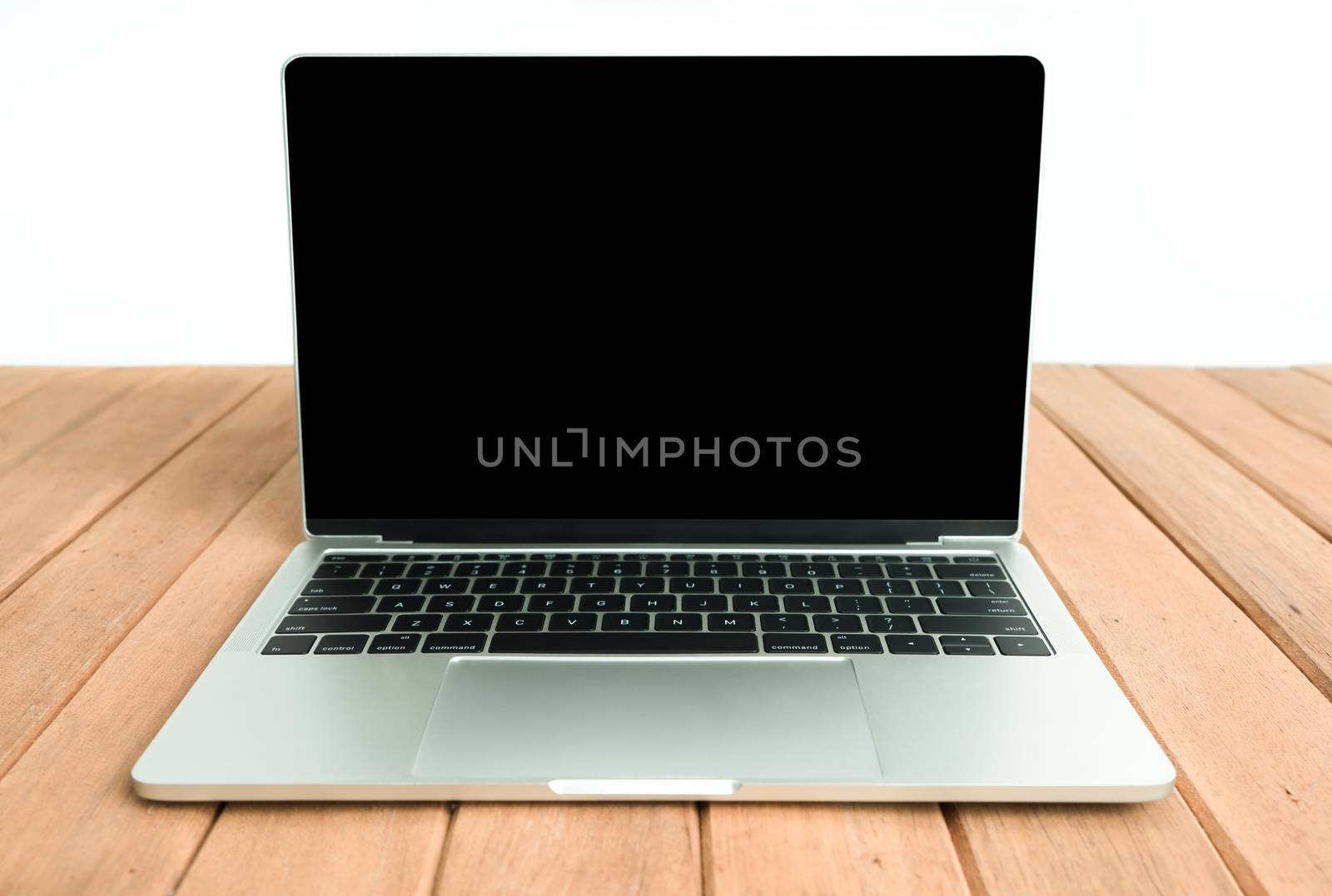 Laptop with black screen on wooden table.  Object for technology by Buttus_casso