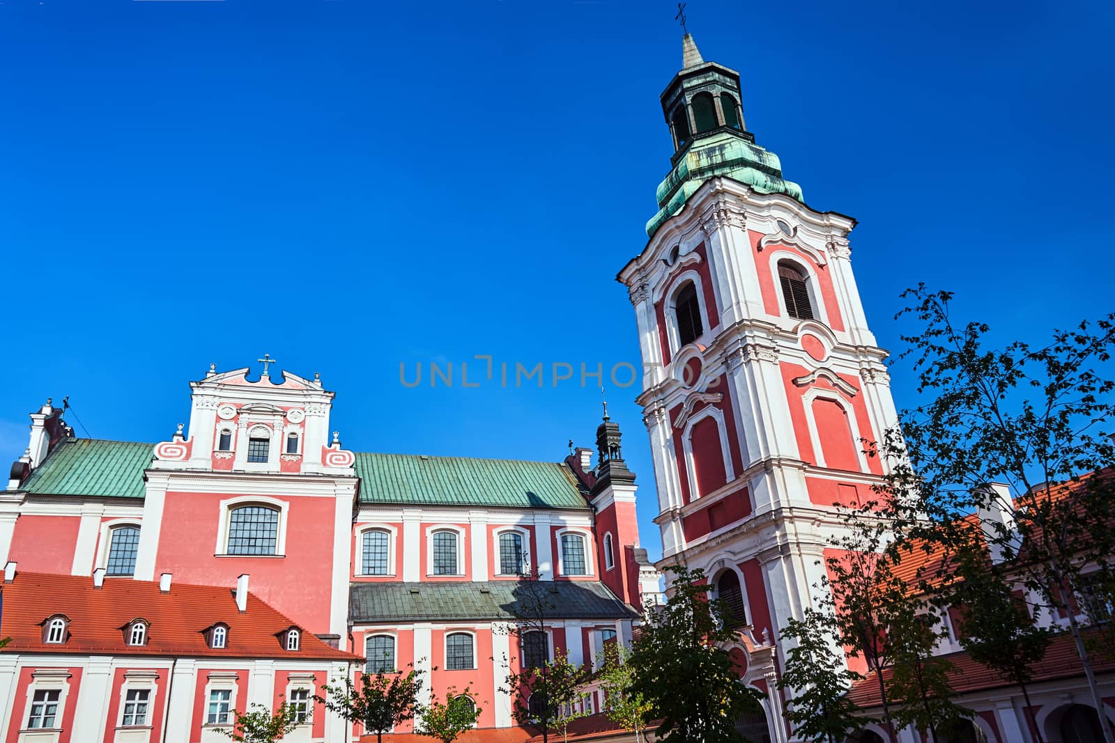 facade of the Baroque Catholic Church with belfry in Poznan