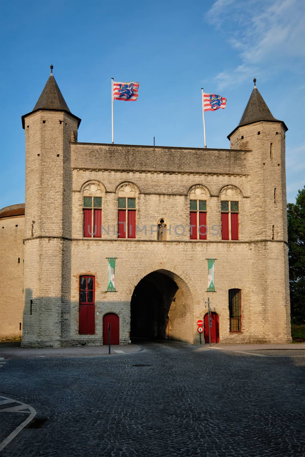 Kruispoort also called Kruispoort gate with heavy towers in Bruge, Belgium on sunset