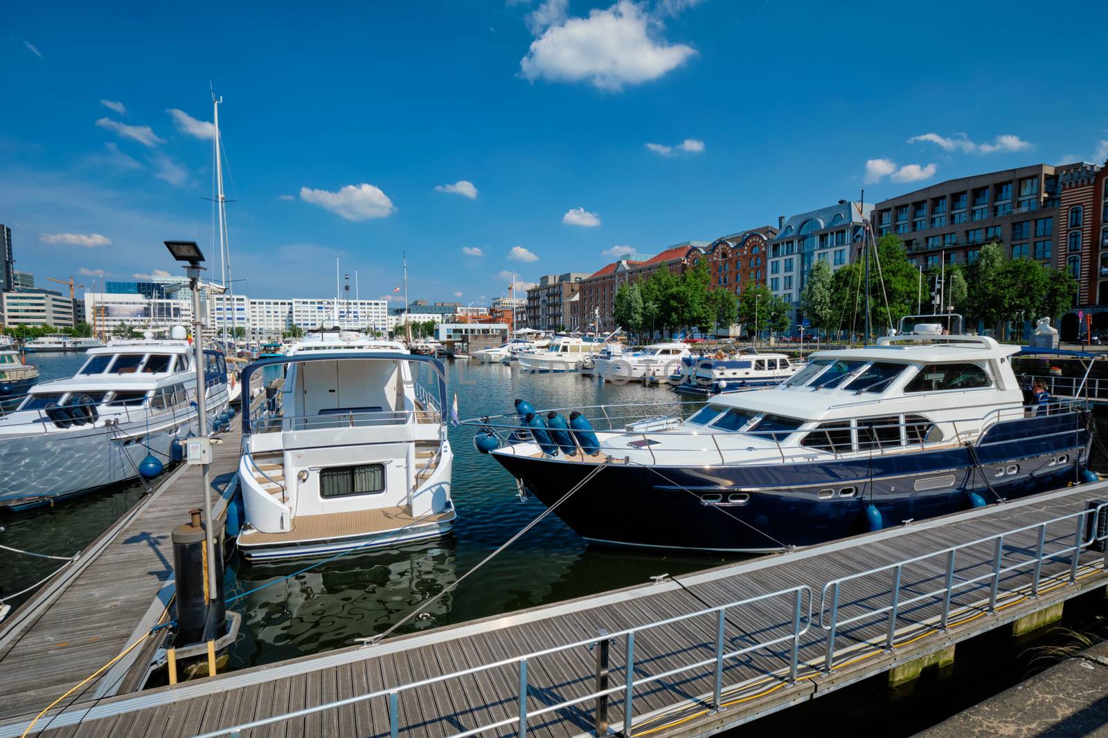 Yachts and boats moored in Willemdock in Antwerp, Belgium by dimol