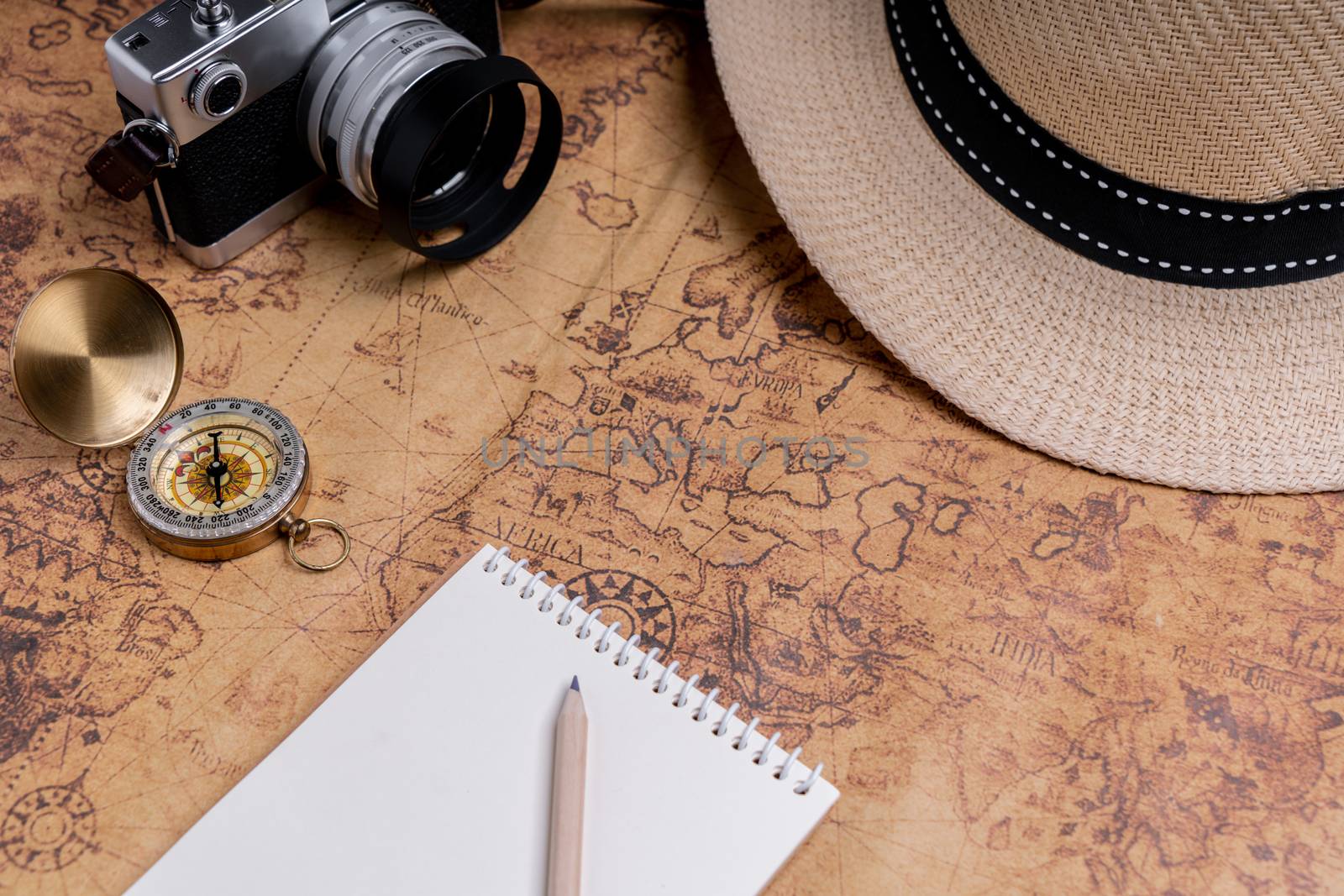 Compass and accessories on map for travel planning