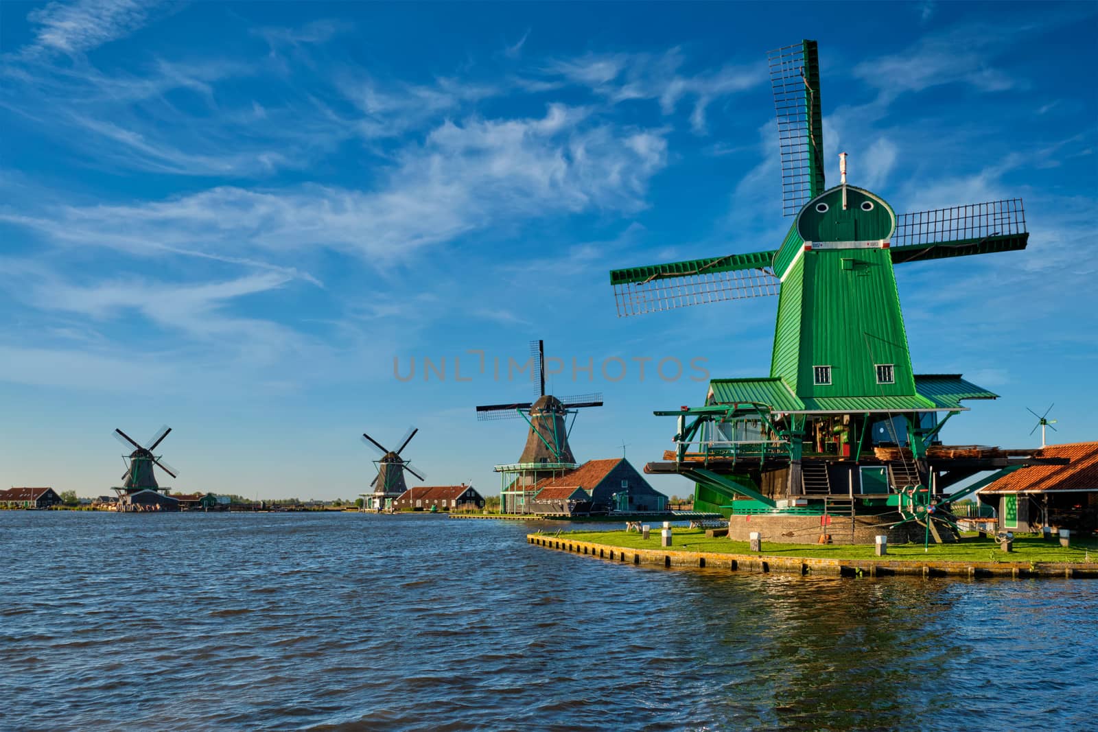 Windmills at Zaanse Schans in Holland on sunset. Zaandam, Netherlands by dimol