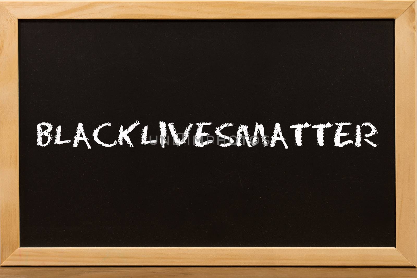 Blacklivesmatter text with copy space on blackboard.