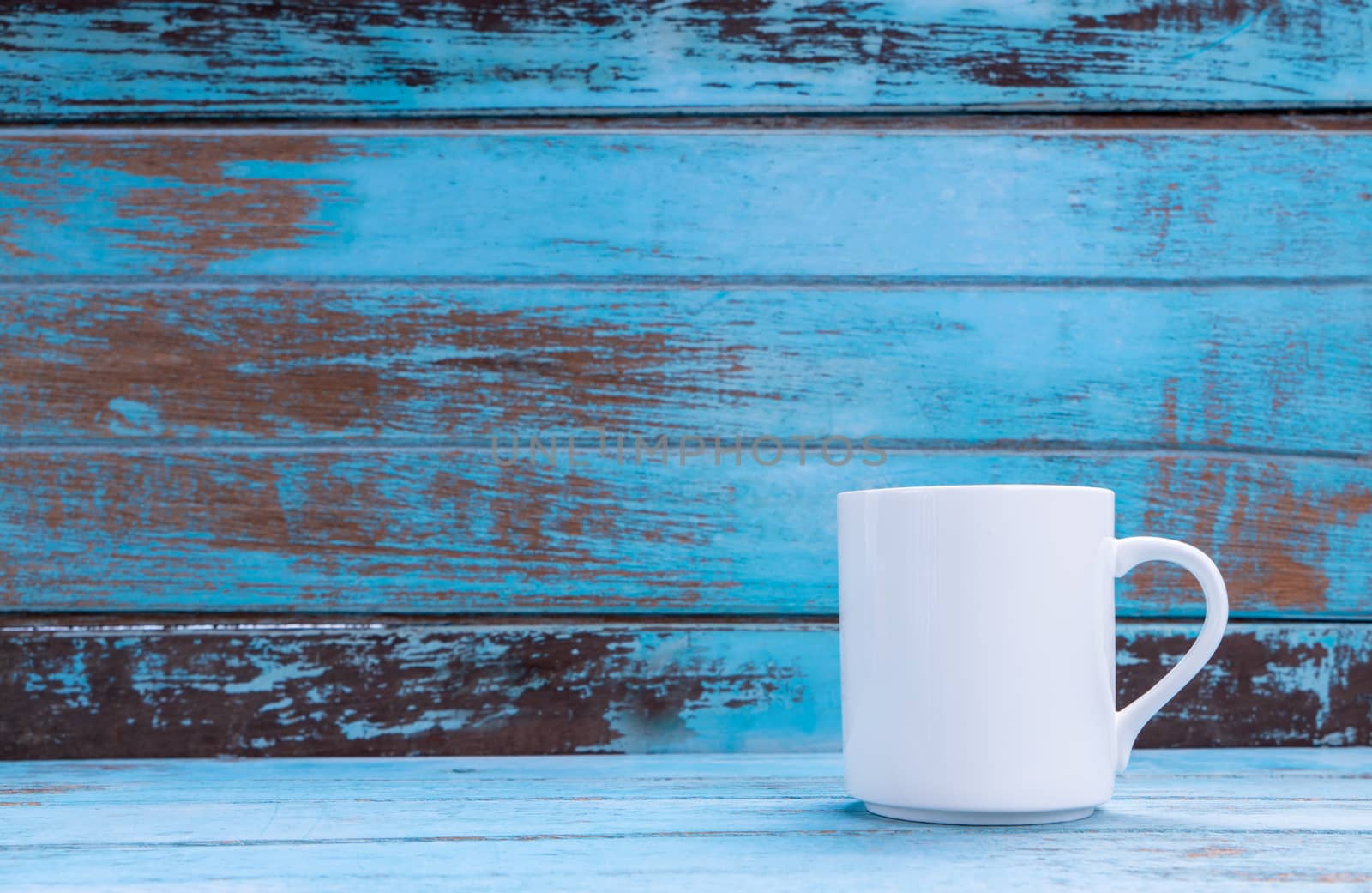 White mug, Coffee cup on blue wooden table by Buttus_casso
