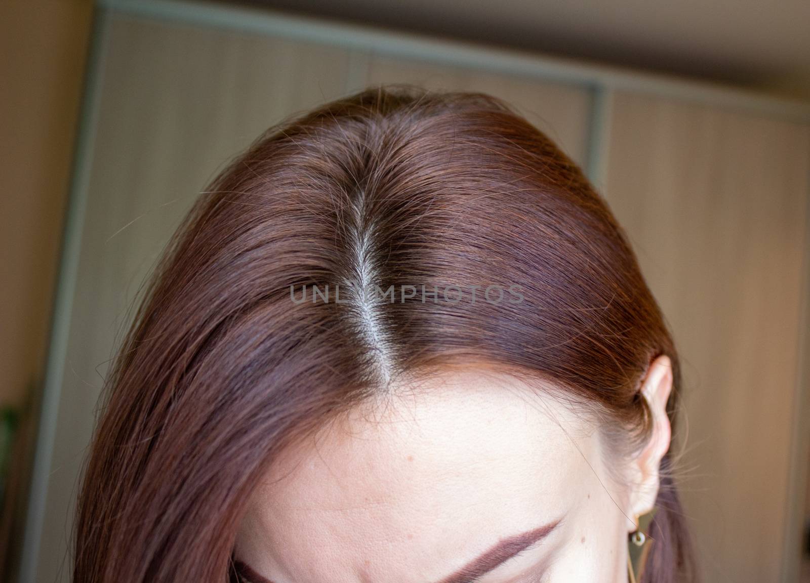 hair on a woman's head close-up. Hair brown color of. by AnatoliiFoto