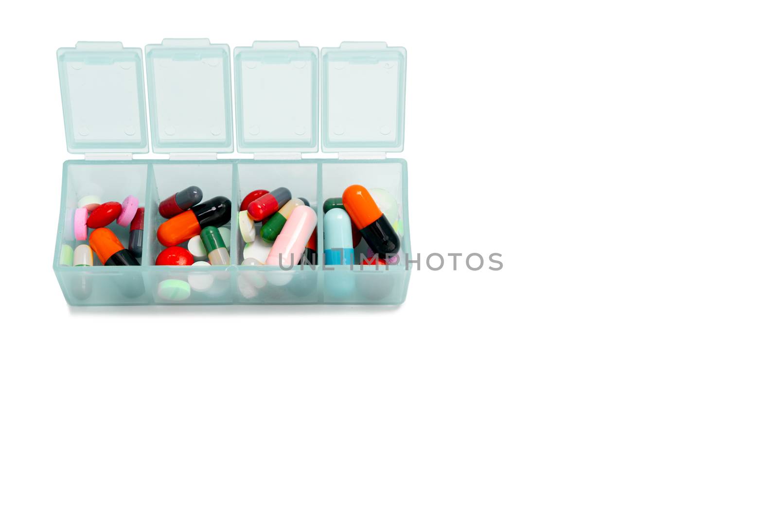 Pills in plastic box with copy space on isolated white