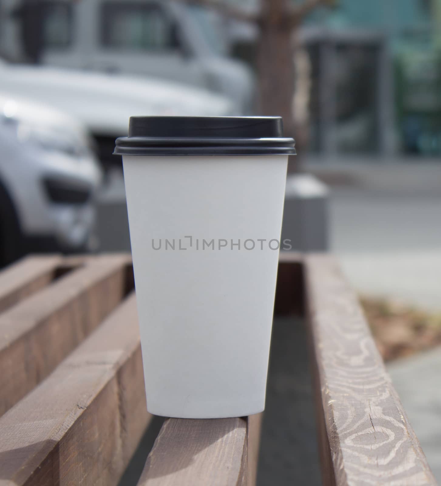 white paper coffee Cup with black plastic lid, outside. Coffee advertising by AnatoliiFoto