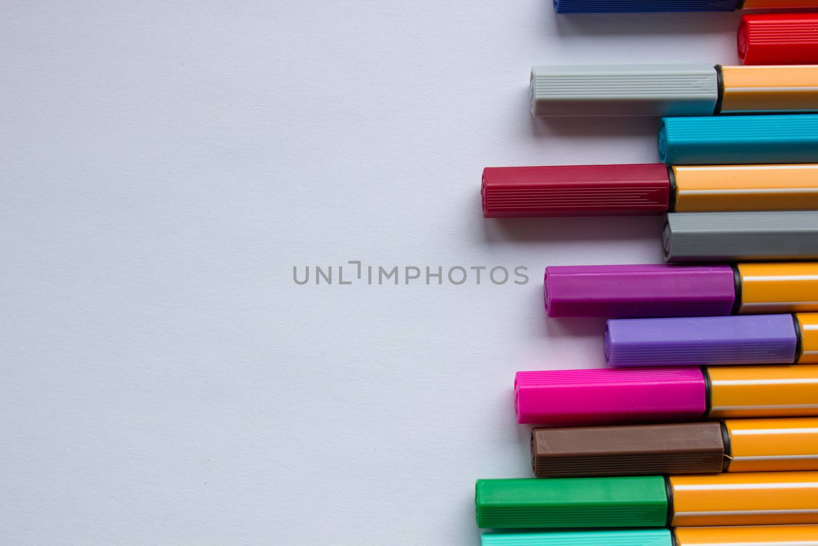 Many different colored pens. Color pencils isolated on a white background.