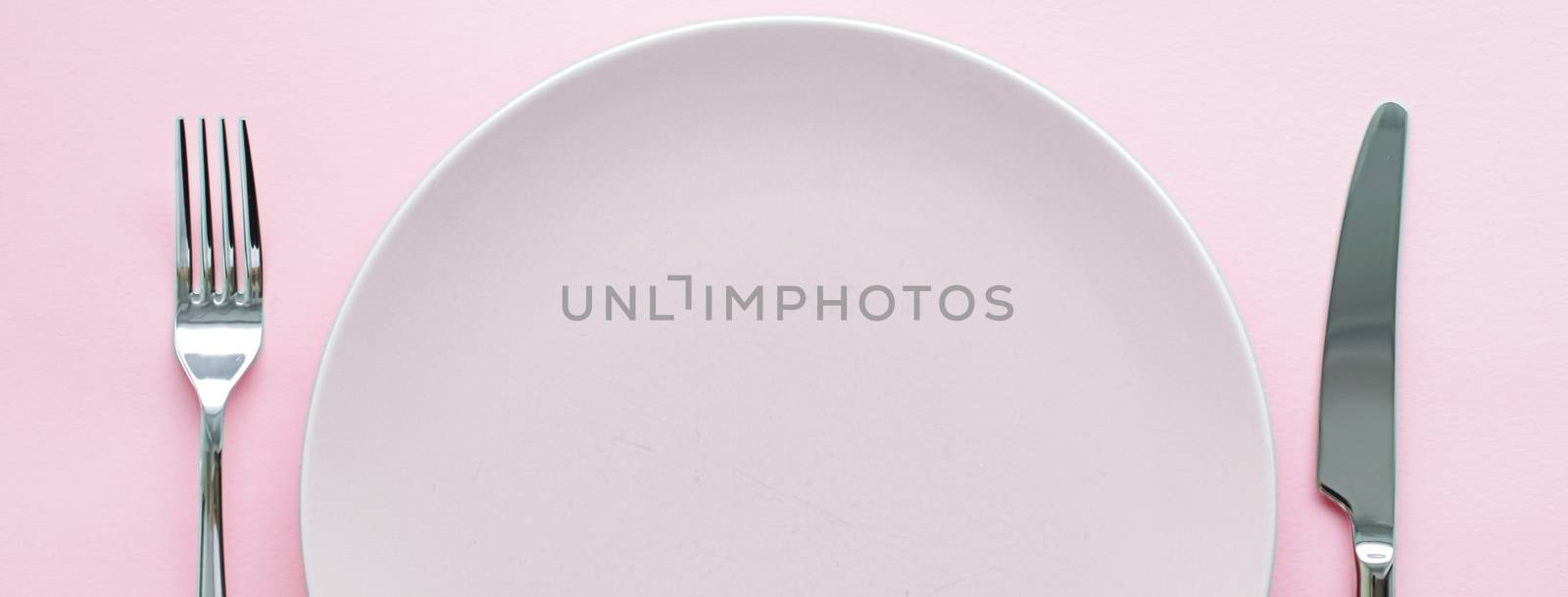 Empty plate and cutlery as mockup set on pink background, top tableware for chef table decor and menu branding design