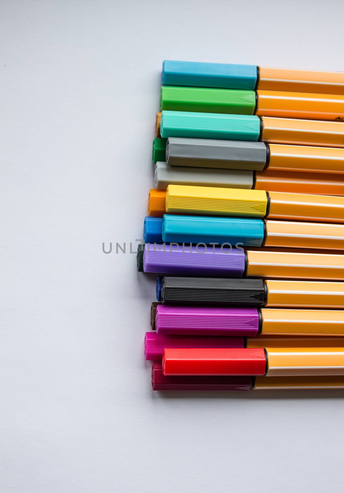 Many different colored pens. Color pencils isolated on a white background.