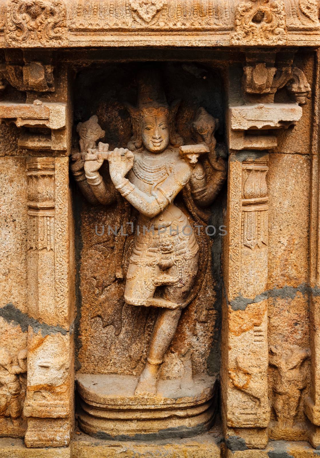 Krishna playing flute bas relief in Hindu temple. Sri Ranganathaswamy Temple also called Thiruvarangam is an example of Dravidian Architecture. Srirangam, Tiruchirappalli, Tamil Nadu, India