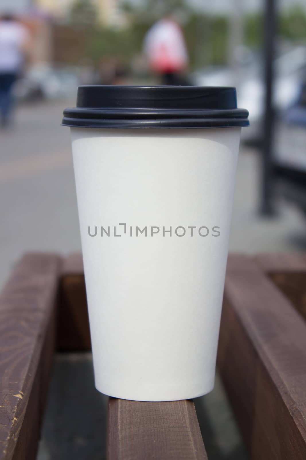 Breakfast and coffee theme: white paper coffee Cup with black plastic lid, outside. Coffee advertising