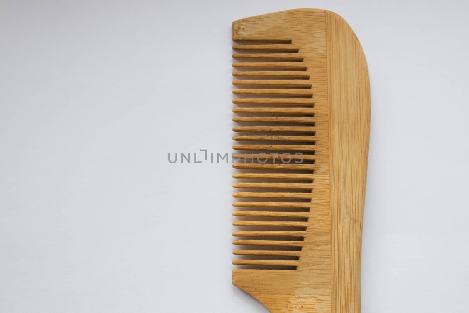 Wooden comb isolated on white background with clipping path. by AnatoliiFoto