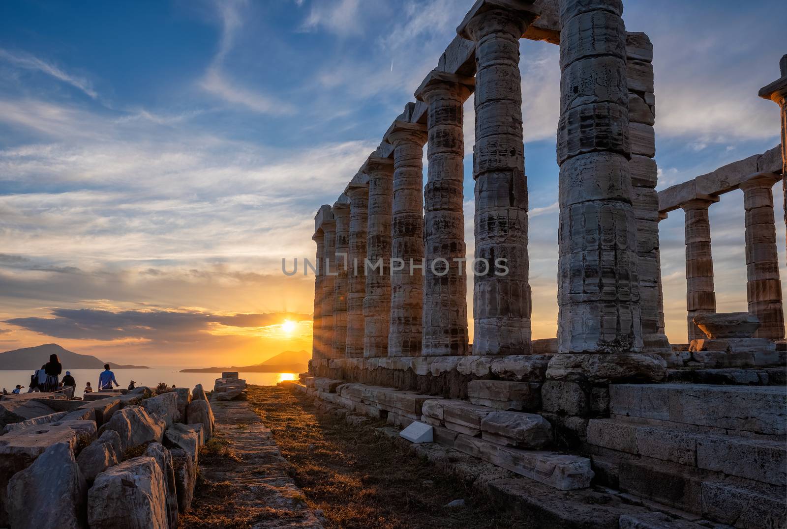 Cape Sounio sunset at Sounion with ruins of the iconic Poseidon temple. One of the Twelve Olympian Gods of ancient Greek religion and mythology. God of the sea, earthquakes. Aegean coast, Greece.