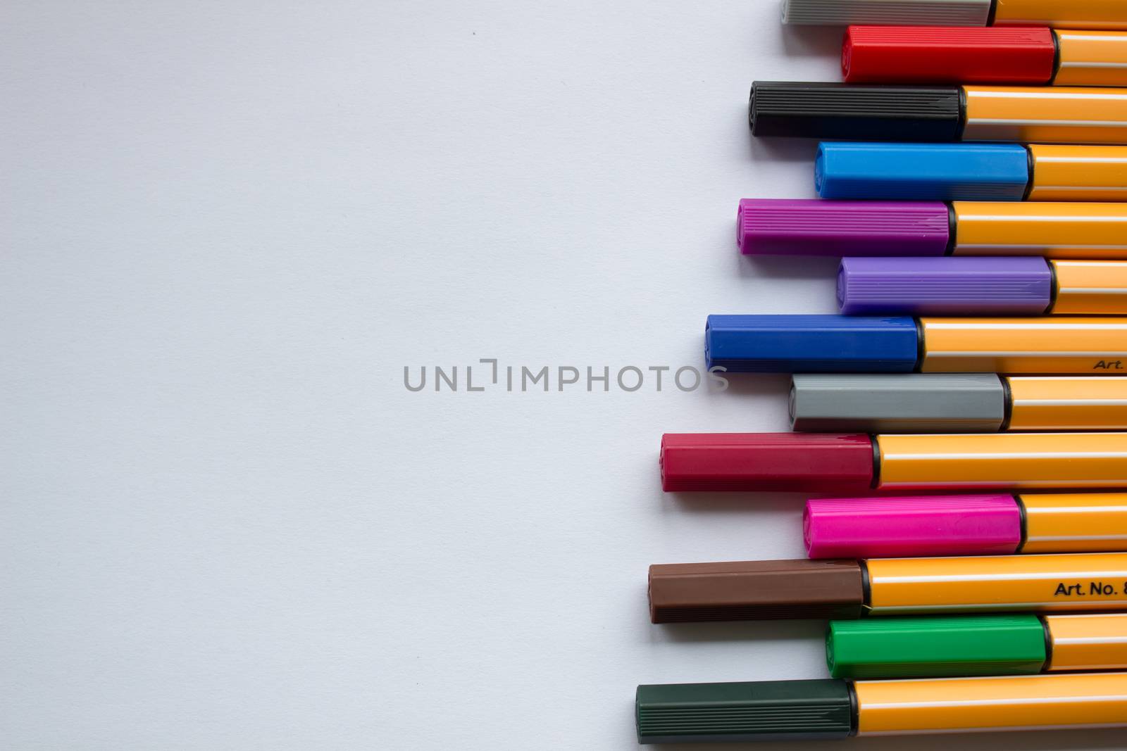 Many different colored pens. Color pencils isolated on a white background.