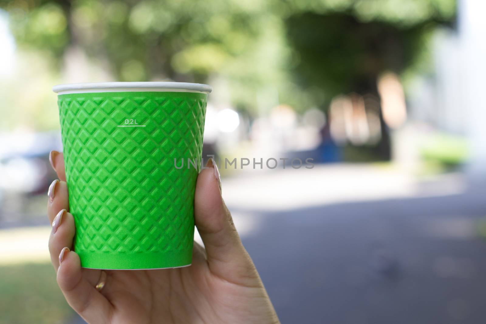 Mock up of cup coffee in woman's hand bright background for break, energy and strength, hot drink in paper cup. by AnatoliiFoto