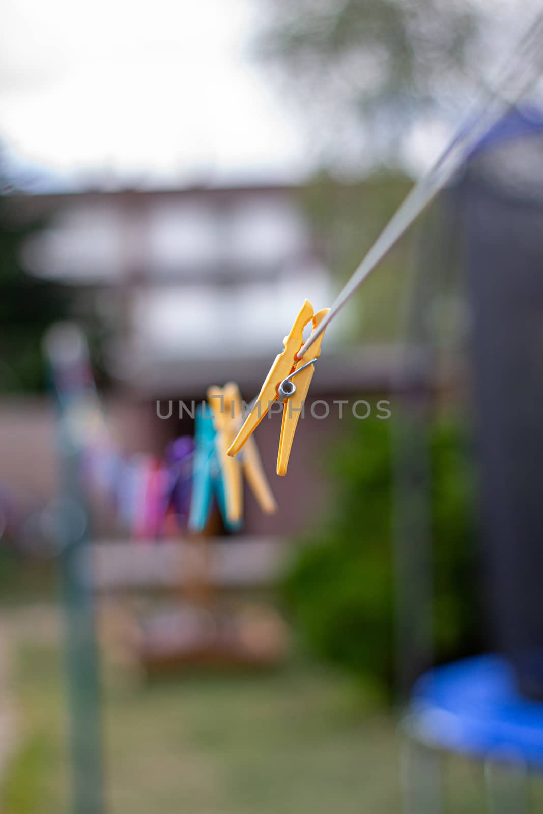 Colorful plastic clothespins on the hangers, clothespins on the hangers rope for wash clothes.
