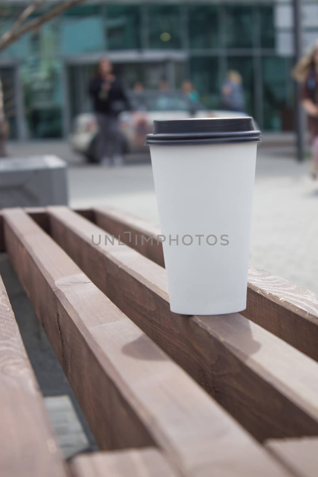 Breakfast and coffee theme: white paper coffee Cup with black plastic lid, outside. Coffee advertising