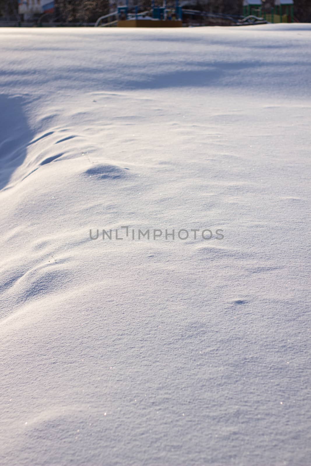 many tracks on the glade covered with snow, paths in the snow, snow-covered meadow.