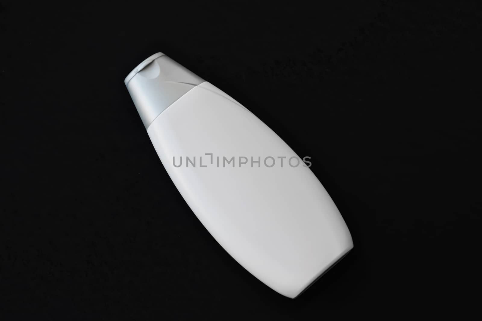 Blank label cosmetic container bottle as product mockup on black background by Anneleven