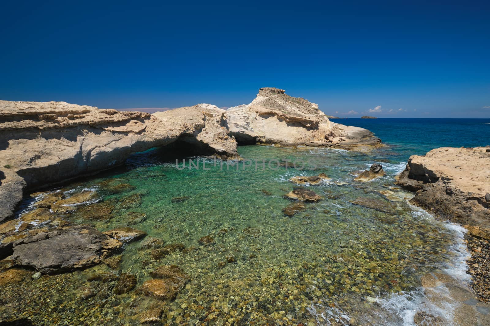 The beach of Agios Konstantinos with crystal clear turquoise water and rock formations in Milos island, Greece