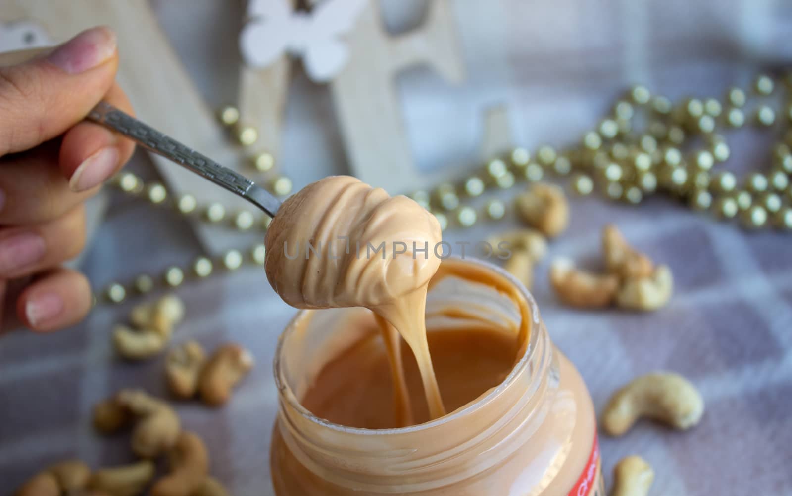 Creamy peanut butter and spoon on background.