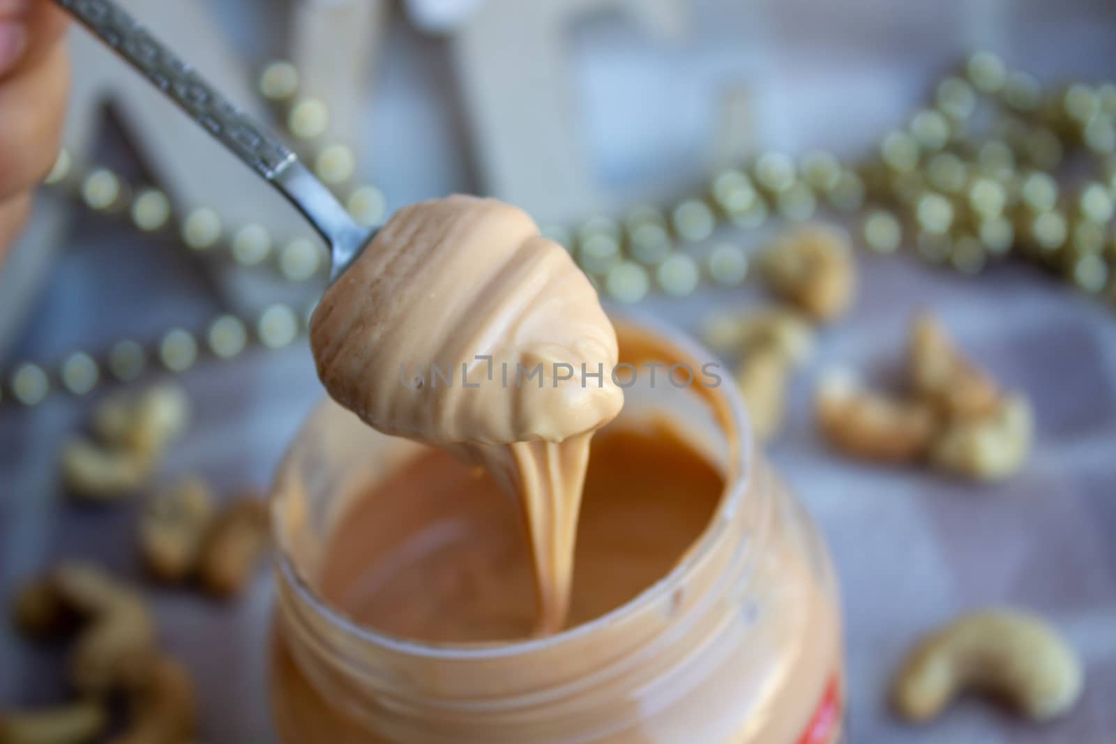 Creamy peanut butter and spoon on background.