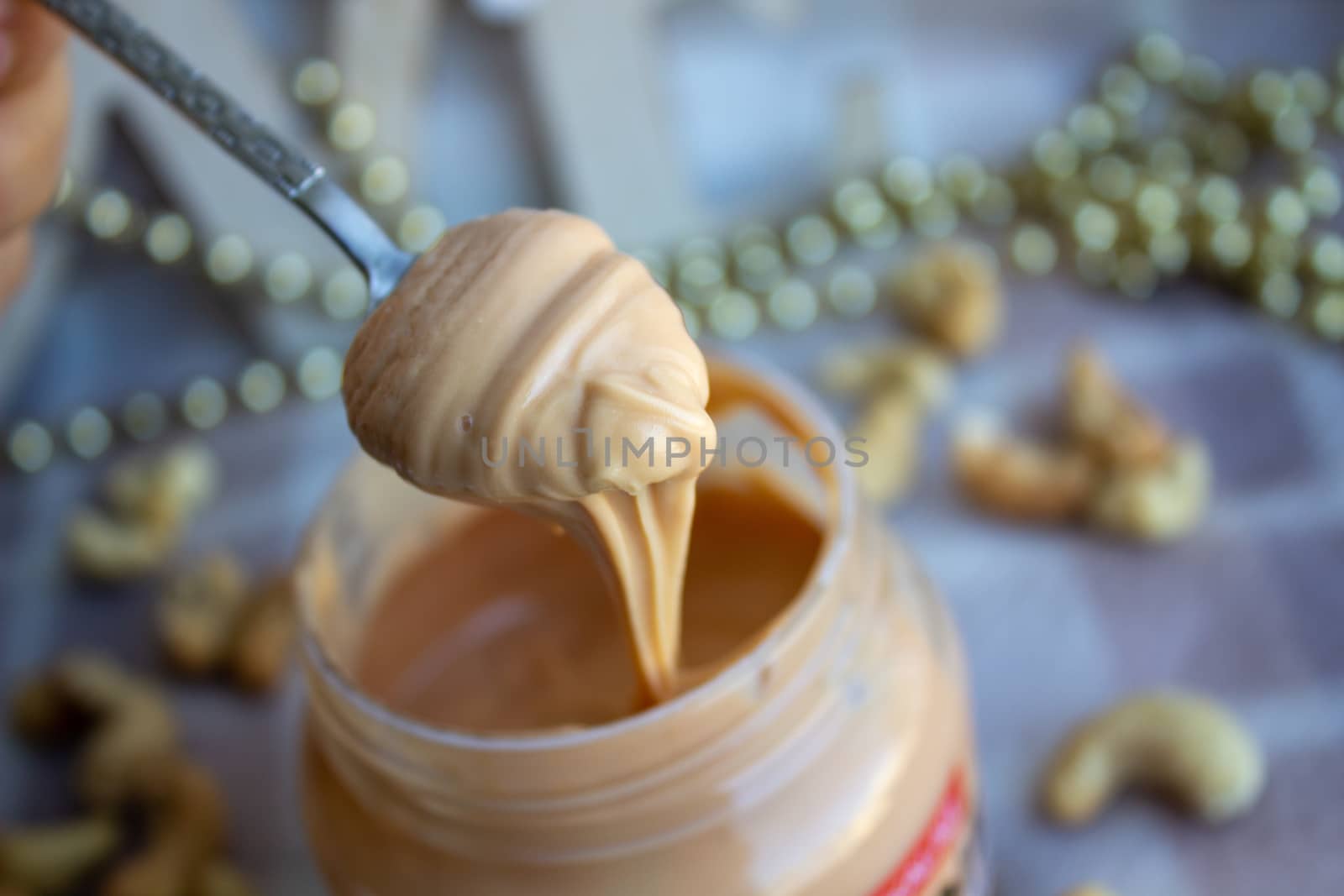 Creamy peanut butter and spoon on background.