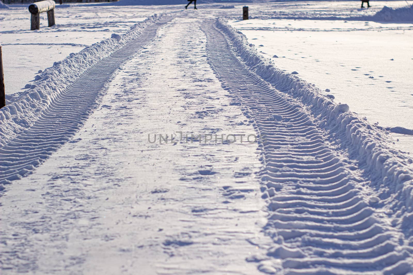 Fresh tracks from the tractor in the snow in winter. by AnatoliiFoto