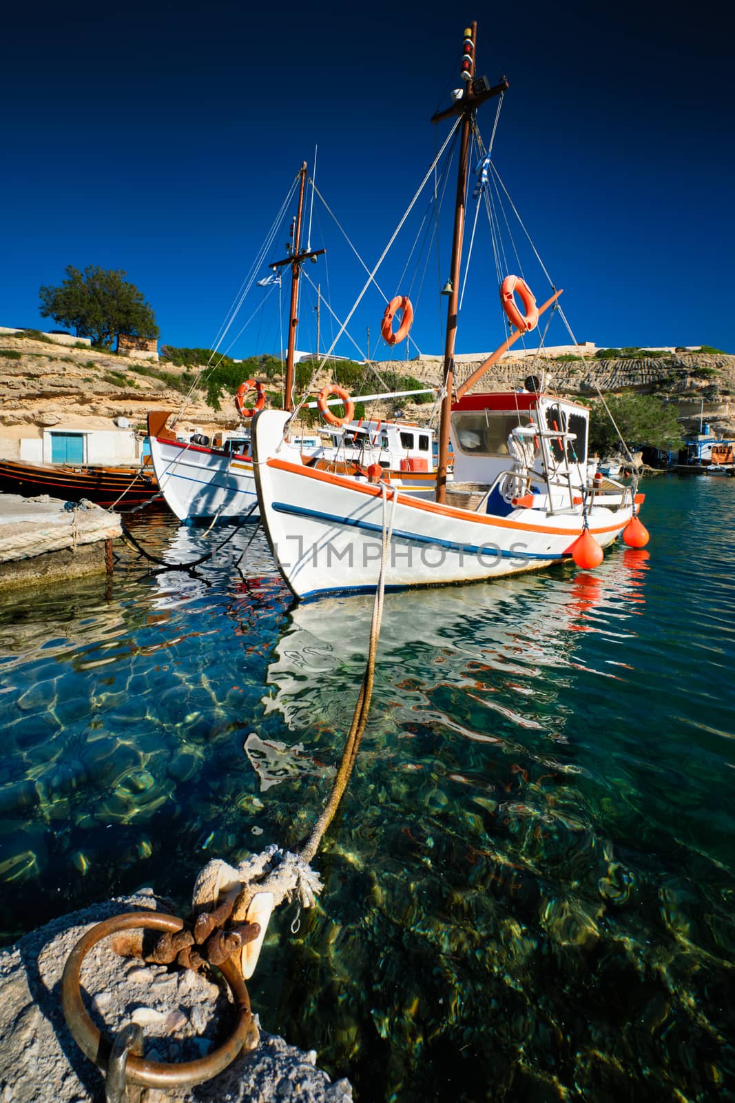 Fishing boats in harbour in fishing village of Mandrakia, Milos island, Greece by dimol