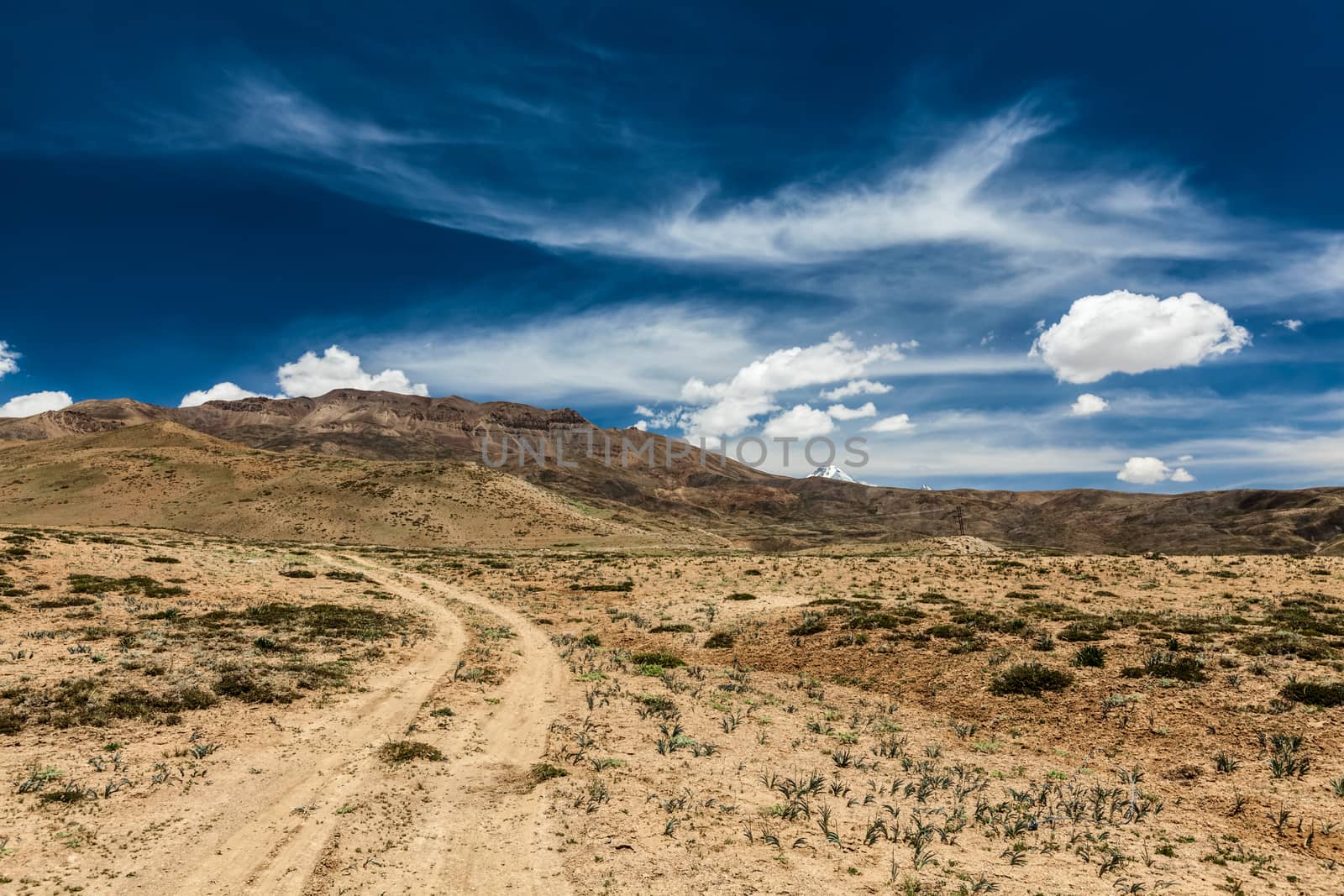 Dirt road in Spiti valley in Himalayas. Spiti valley, Himachal Pradesh, India by dimol