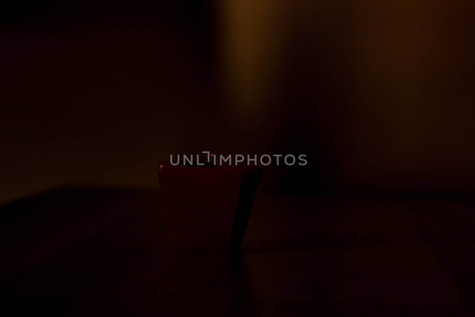 Extinguished candle on black background with copy space.