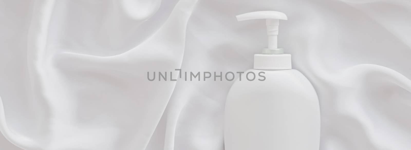 Blank label cosmetic container bottle as product mockup on white silk background, hygiene and healthcare