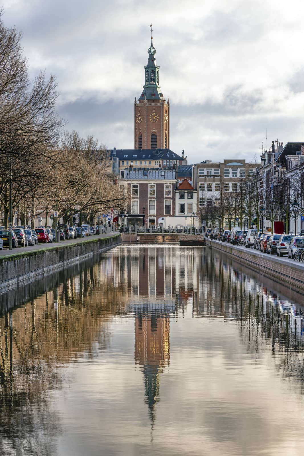 Saint James church reflected on the canal calm water nested to the royal stable, in The Hague 