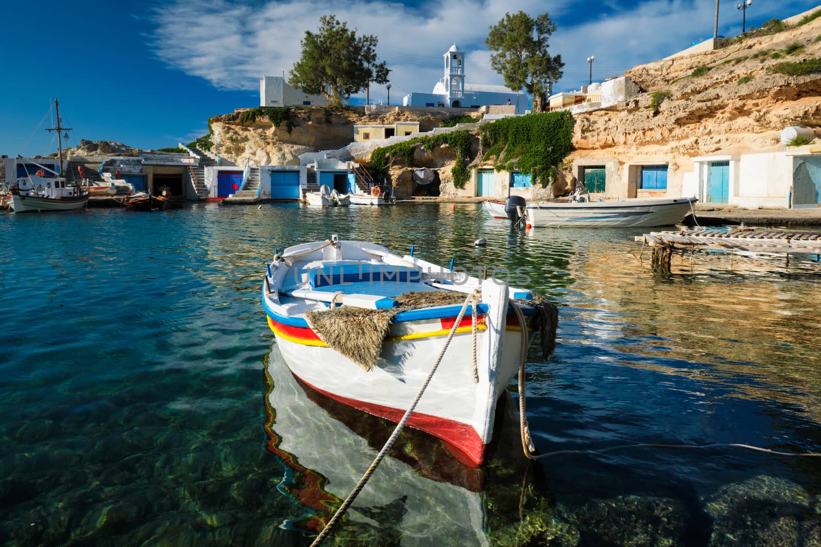 Fishing boats in harbour in fishing village of Mandrakia, Milos island, Greece by dimol