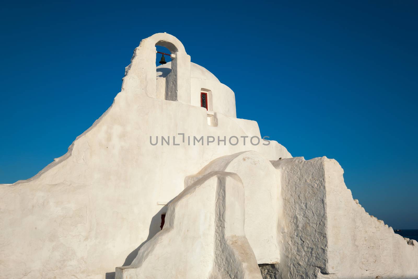 Famous tourist landmark of Greece - Greek Orthodox Church of Panagia Paraportiani in town of Chora on Mykonos island, Greece on sunrise