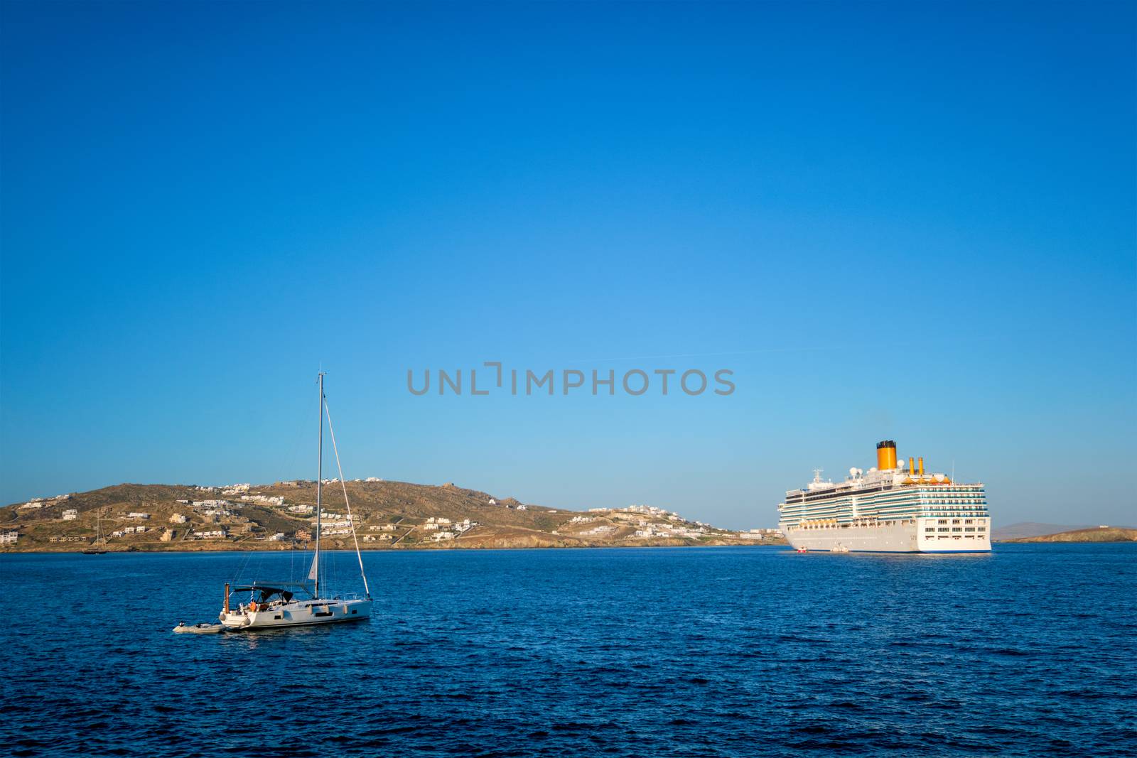 Boat yacht and cruise liner is Aegean sea on beautiful summer day. Chora, Mykonos island, Greece