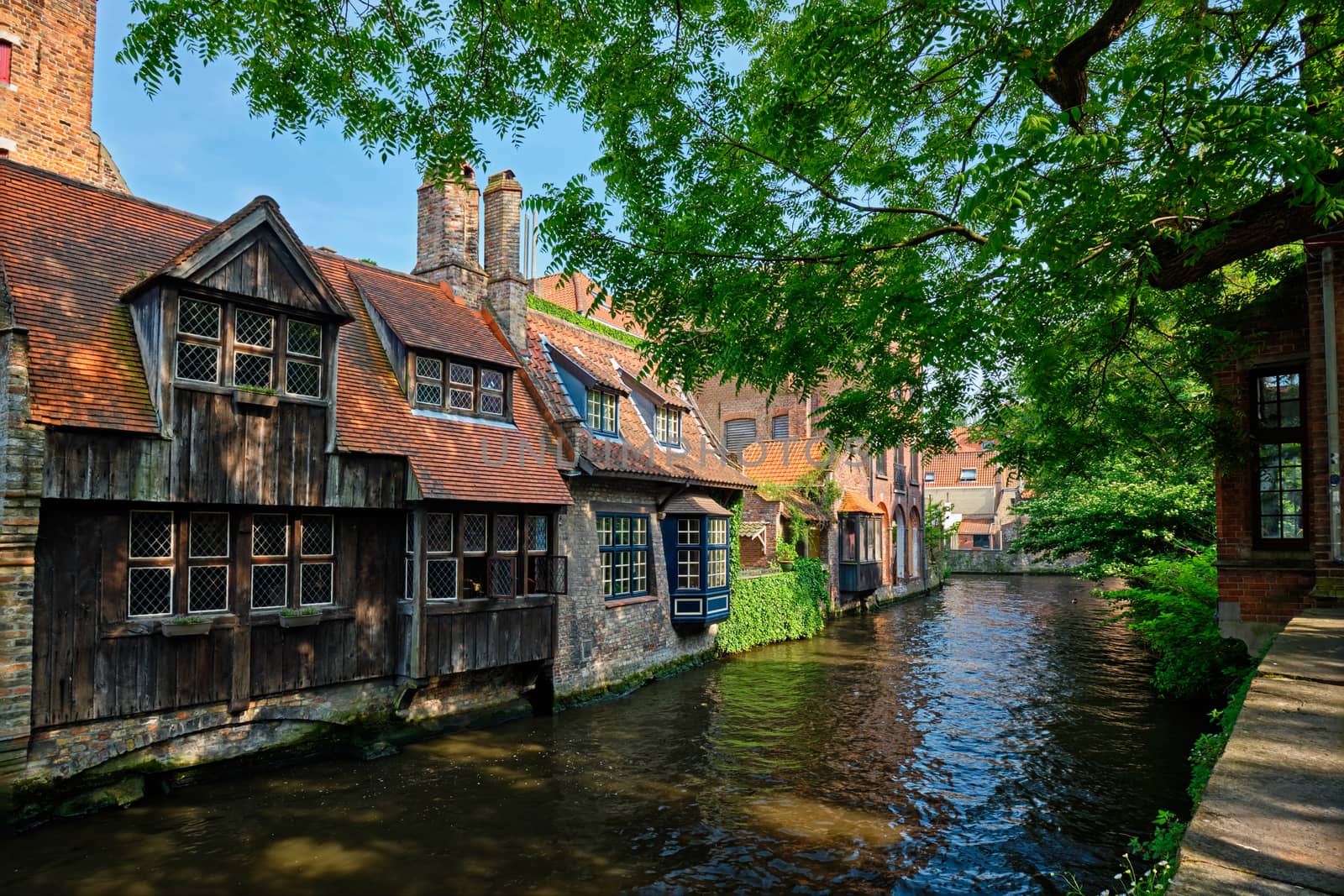 Canal between old houses of famous Flemish medieval city Brugge. Bruges, Belgium