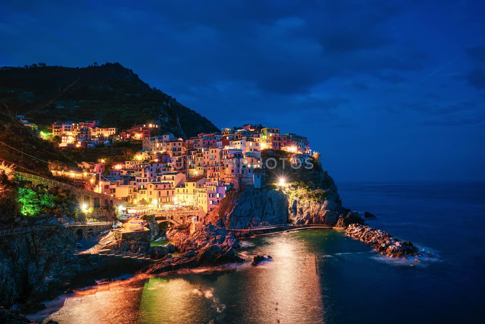 Manarola village popular european italian tourist destination in Cinque Terre National Park UNESCO World Heritage Site, Liguria, Italy illuminated in the evening